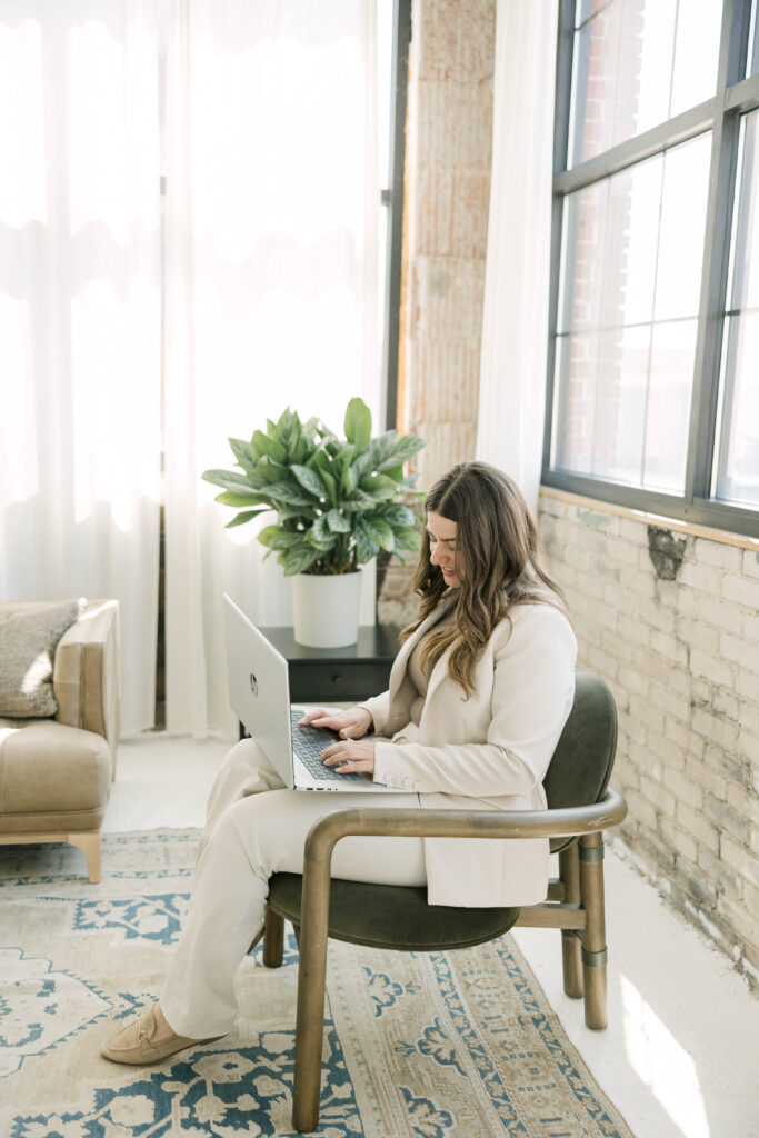 Lifestyle brand photo of Milwaukee real estate agent working on laptop