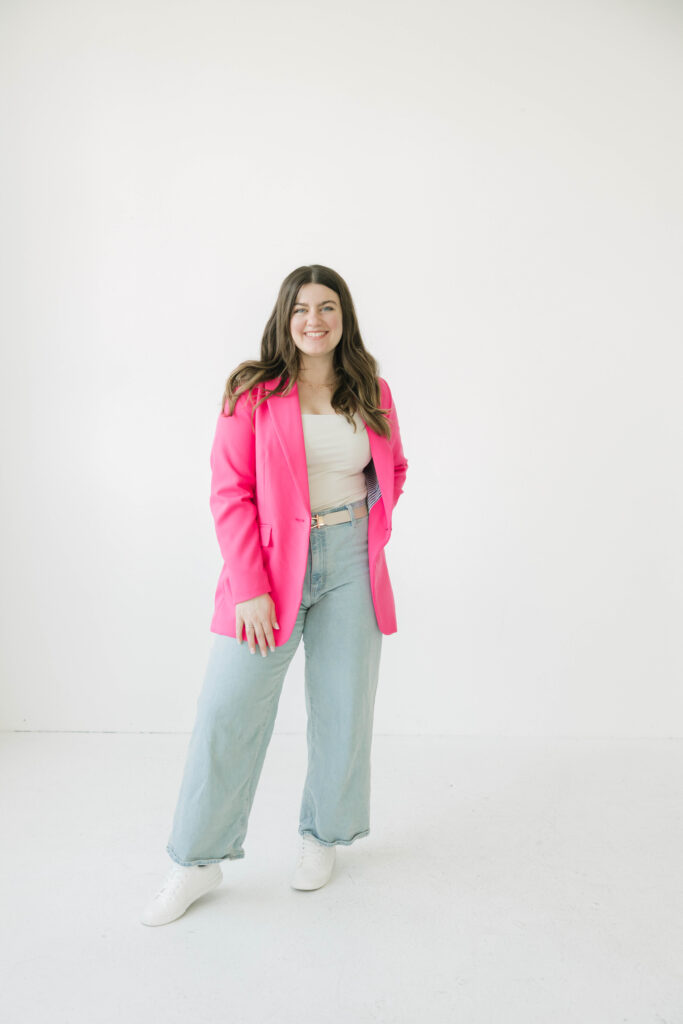 Milwaukee realtor brand photoshoot at Studio North featuring a pink blazer and power pose