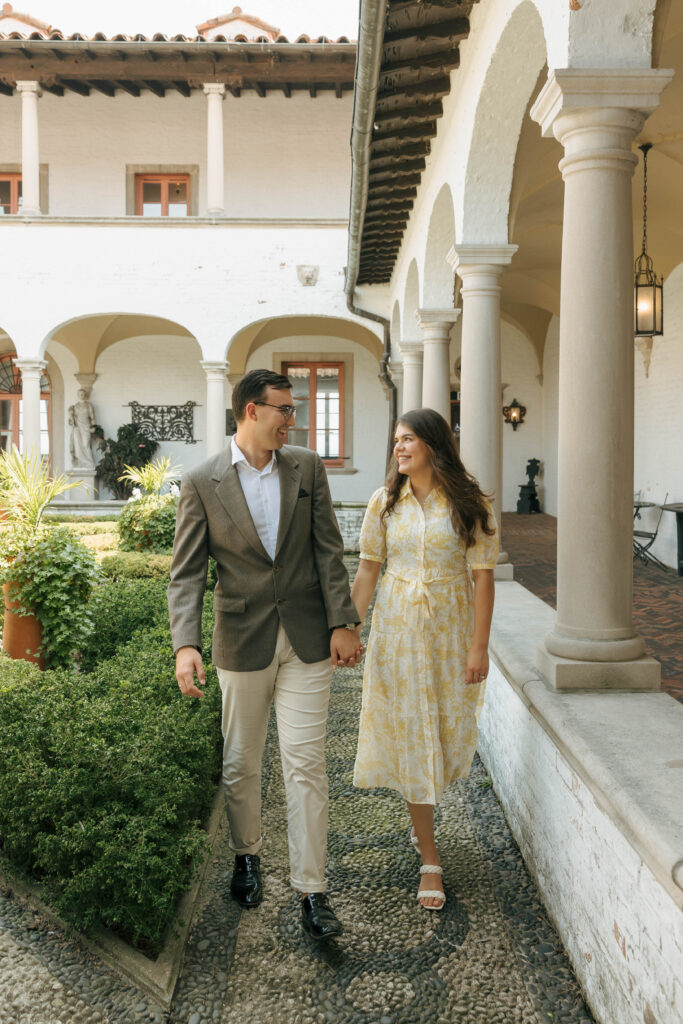 Couple walking through the gardens at Villa Terrace during their engagement session