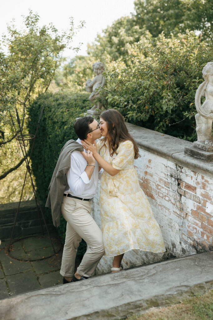 Editorial-style engagement photo on the stone staircase at Villa Terrace
