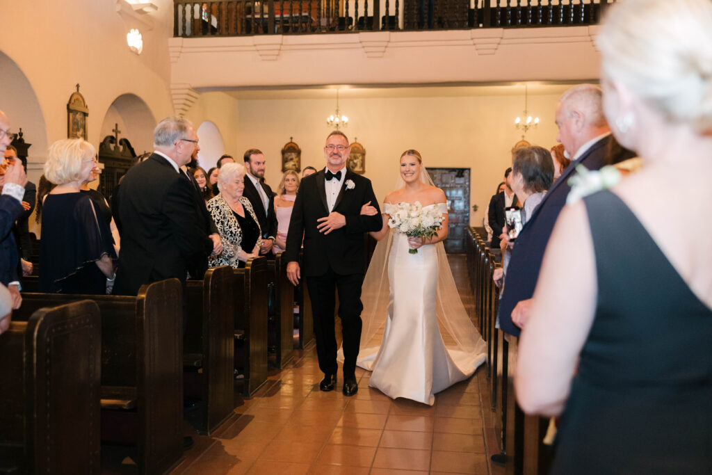 Father walking bride down the aisle at Brophy Chapel from a luxury Phoenix wedding.