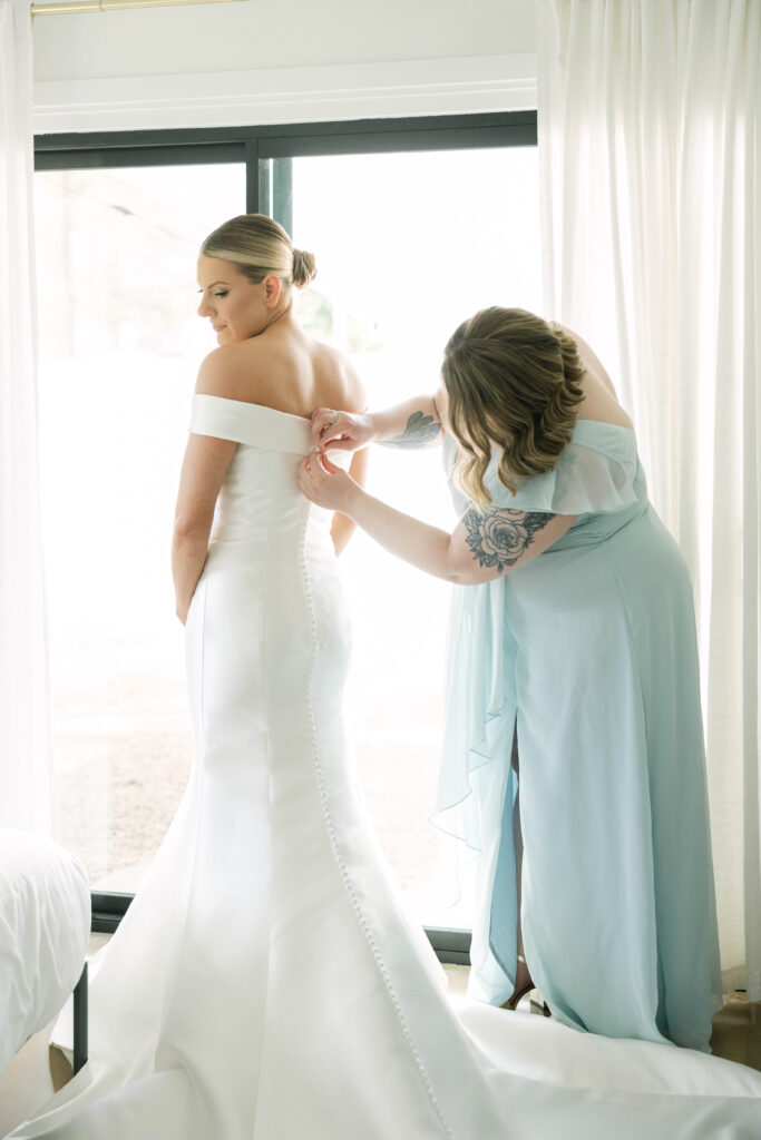 Bride putting on dress for her wedding in Phoenix, Arizona