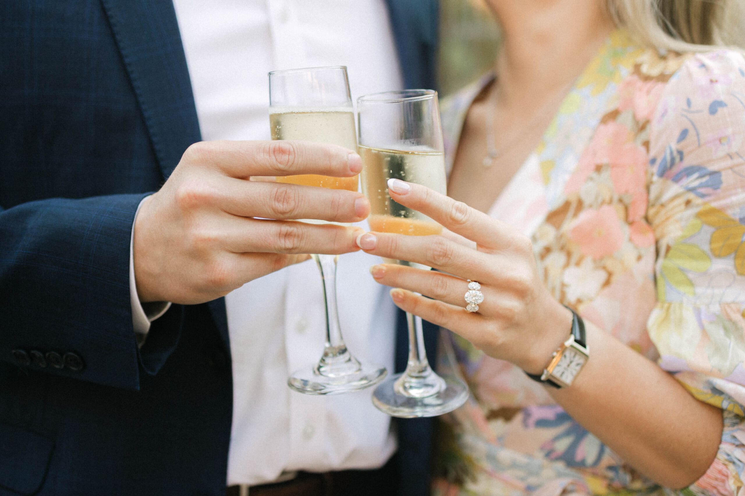 Close-up of an engaged couple toasting with champagne after getting engaged at the American Club in Kohler.