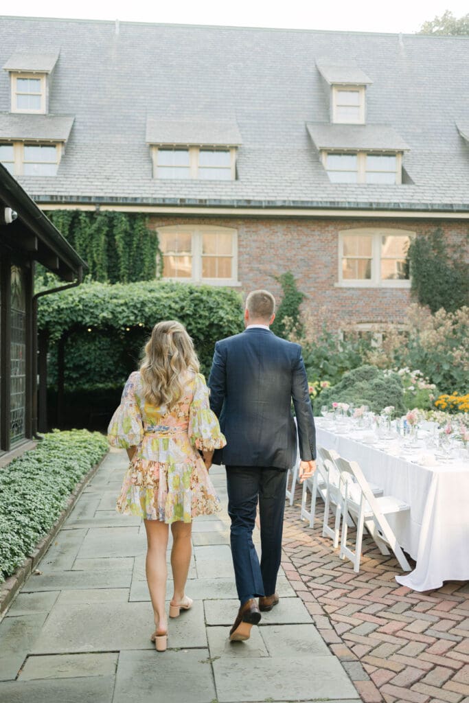 Documentary-style photo of engaged couple walking at The American Club in Kohler
