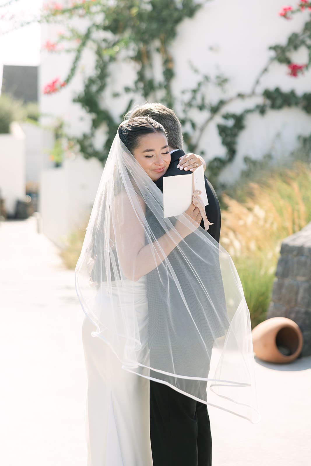 Emotional hug during couple's vows at their Santorini wedding
