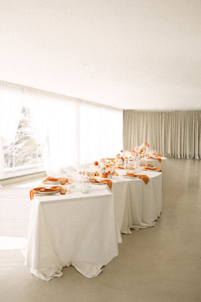 colorful wedding tablescape with pink and orange florals Santorini