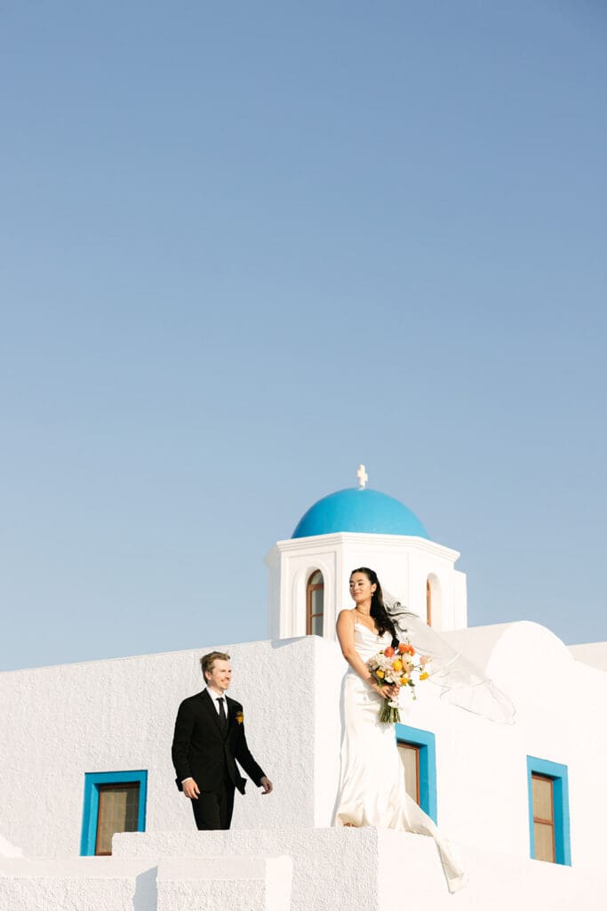 couple portraits at a cliffside chapel in Santorini