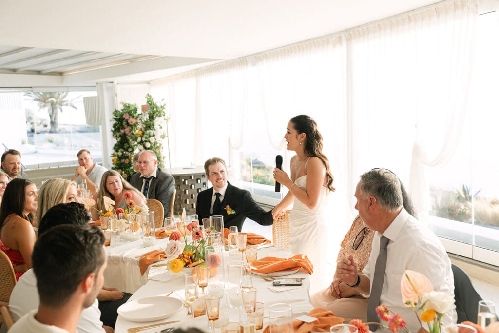 bride giving a toast during Santorini wedding reception