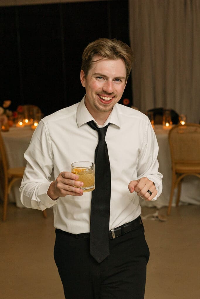 Groom dancing at his Santorini wedding